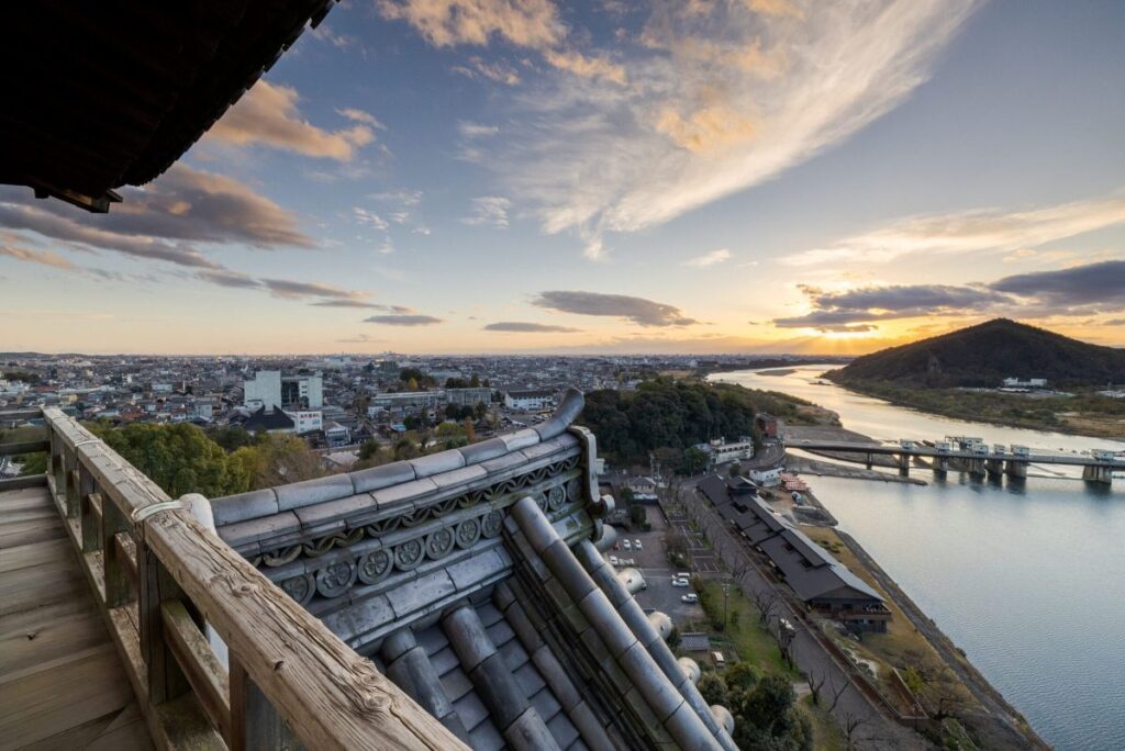 犬山城天守閣の最上階から眺める木曽川と夕暮れ時の街並み。